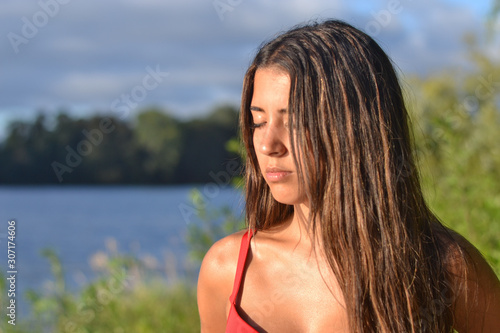 Young woman portrait at the sea side, summer time