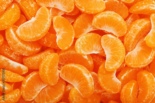 Lots of slices of juicy tangerines as background texture.