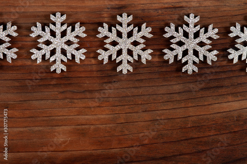 Snowflakes on wooden background