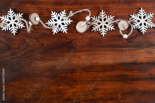 Snowflakes on wooden background with copy space. Top view and flat lay. Pattern.