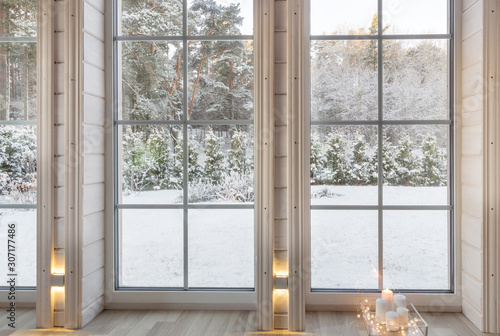 Bright photo studio interior with big window, high ceiling, white wooden floor © Olga Ionina