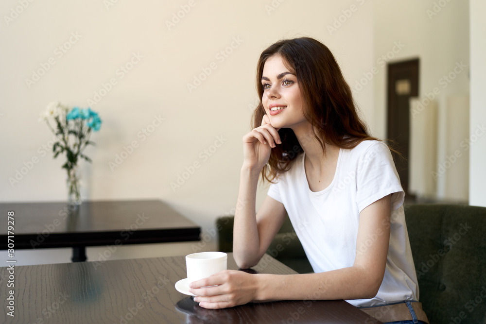 woman sitting on sofa and talking on cell phone woman sitting on sofa and talking on cell phone