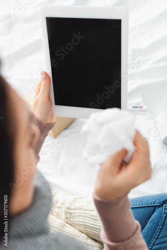 cropped view of ill woman with napkin having online consultation with doctor on digital tablet © LIGHTFIELD STUDIOS
