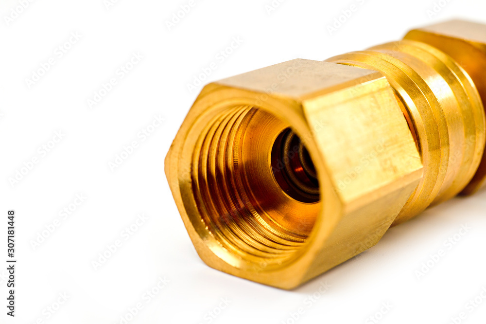 Close-up pneumatic quick coupling made of high-quality yellow metal, close-up shot on a white background Close-up pneumatic quick coupling made of high-quality yellow metal, close-up shot on a white background