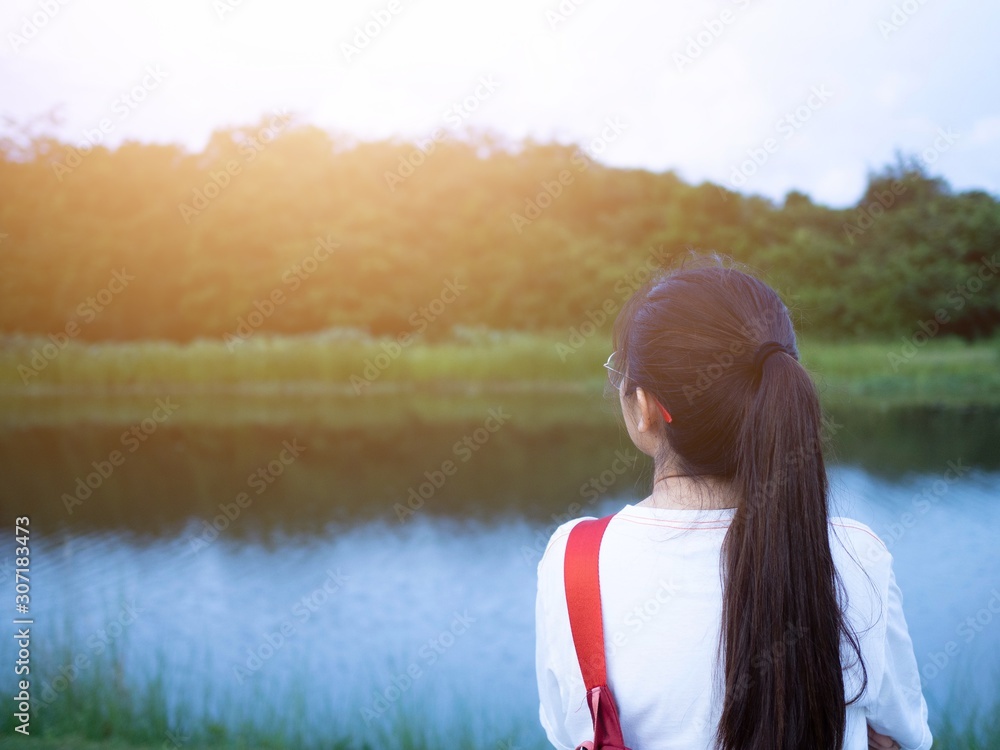 The women turned back and stood looking at nature by the river. The women turned back and stood looking at nature by the river.