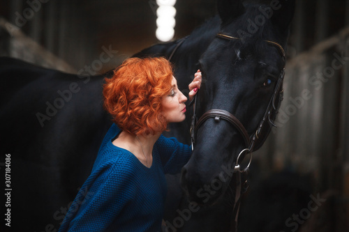 red hair beautiful young woman lifestyle with best friend horse in countryside. portrait of paople and animals for pet life concept outdoor under the sun
