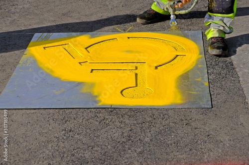 Yellow handicap parking sign spraying on the floor. 