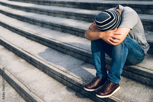 Fotografie image of young man sitting on a stairway,depression