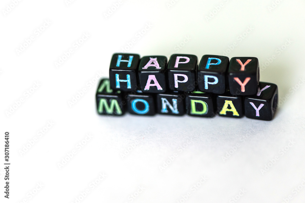 Happy Monday of blocks on white page open notebook on desktop Happy Monday of blocks on white page open notebook on desktop