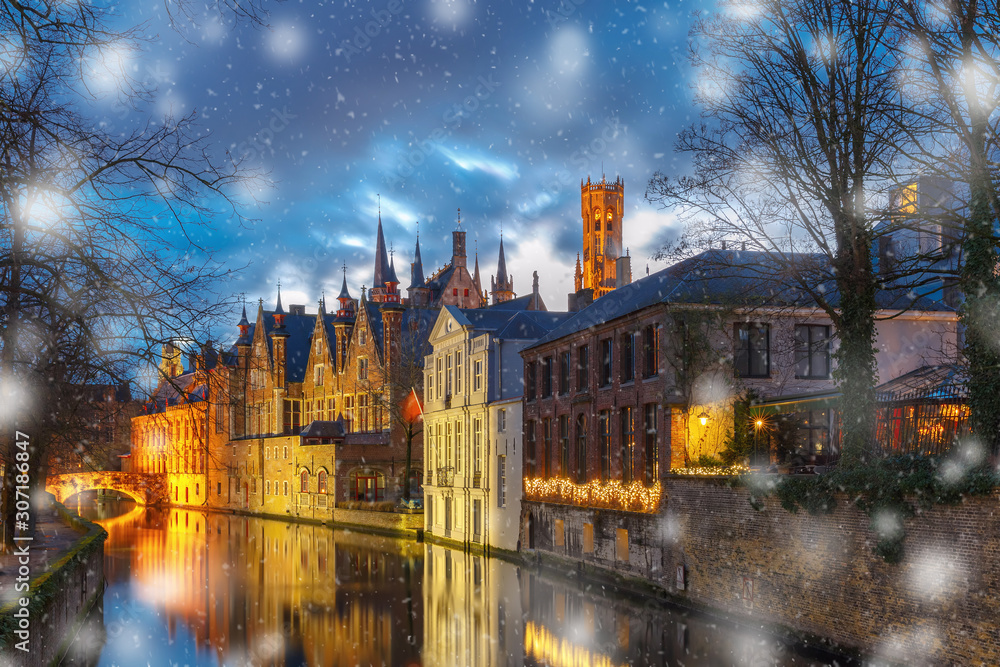 Fototapeta premium Christmas night cityscape with a medieval tower Belfort and the Green canal, Groenerei, in Bruges, Belgium