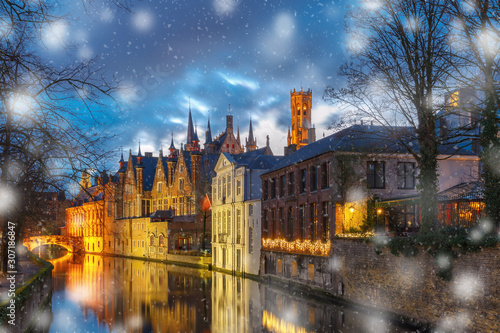 Christmas night cityscape with a medieval tower Belfort and the Green canal, Groenerei, in Bruges, Belgium
