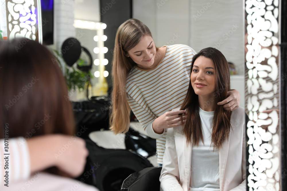 Professional hairdresser working with client in beauty salon Professional hairdresser working with client in beauty salon