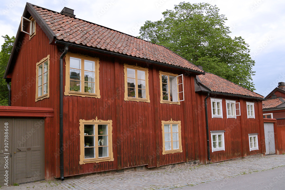 Traditional wooden houses painted in traditional red located in Stockholm, Sweden.