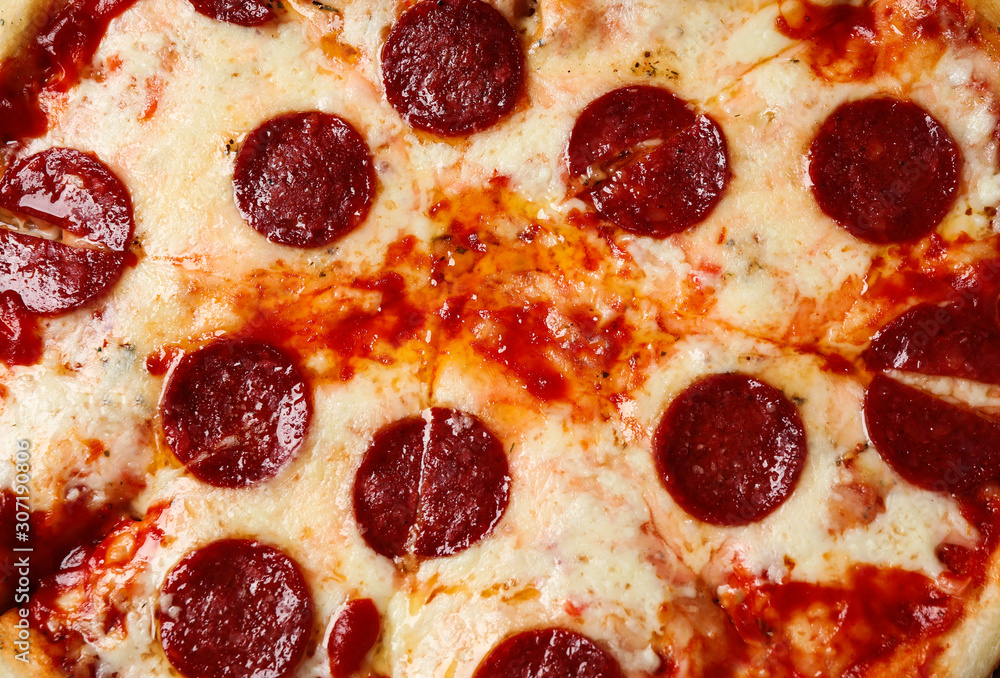 Hot delicious pepperoni pizza with melted cheese, closeup Hot delicious pepperoni pizza with melted cheese, closeup