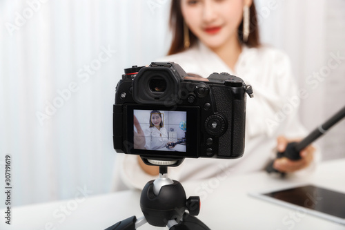 Young asian woman traveler blogger selfie herself with smart phone while recording vlog video live streaming. blogger and vlogger online influencer on social media concept.;