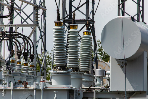 Three phase distribution transformer in an electrical substation, Current transformer, close up on the Ceramic insulators, Elements of a substation