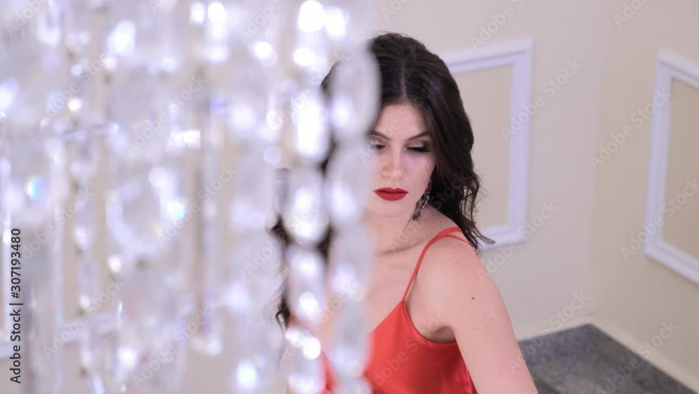 Beautiful woman in a red dress posing. Fashion and style concept. Beautiful woman in a red dress posing. Fashion and style concept.