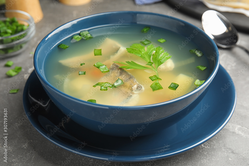 Delicious fish soup served on grey table, closeup Delicious fish soup served on grey table, closeup