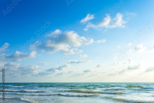 Beautiful early morning sunrise over the sea the horizon,blue sky background texture with white clouds sunset.