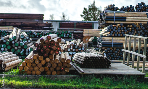 stacked logs with edges on the shore