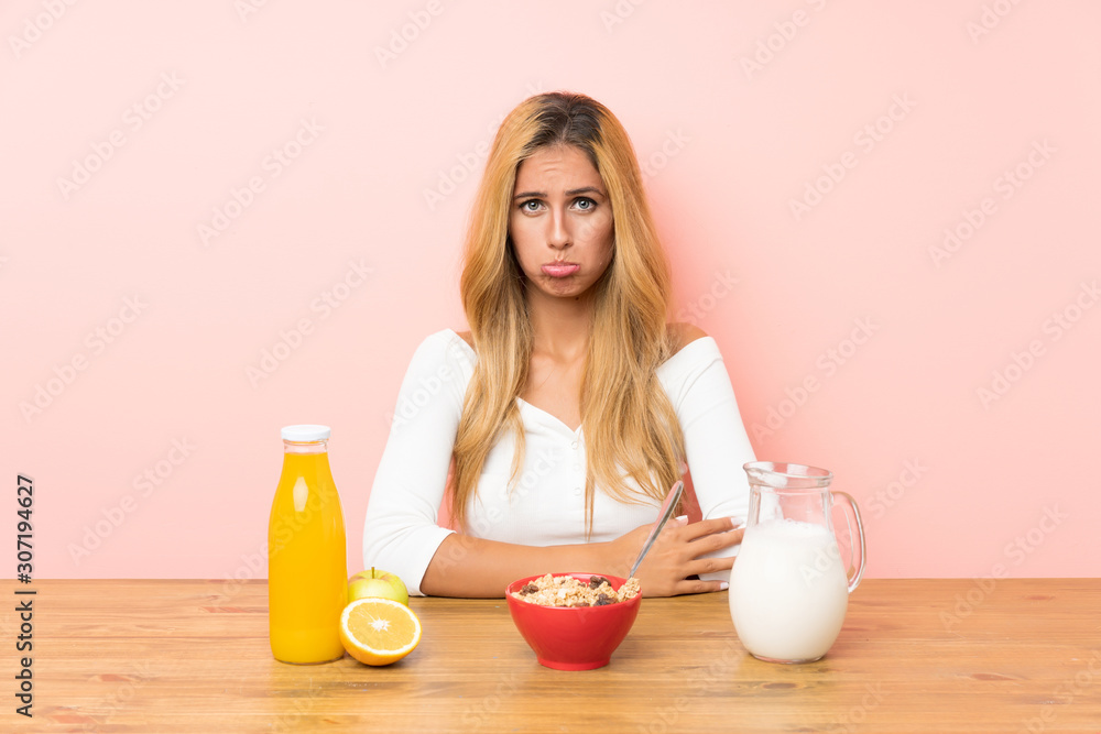 Young blonde woman having breakfast milk sad Young blonde woman having breakfast milk sad