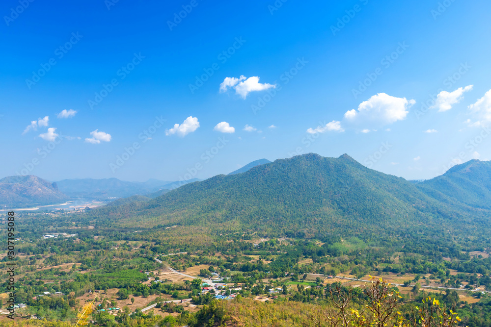 Beautiful panoramic view green forest mountain range Phu Thok Park in Loei province,Thailand, blue sky background texture with white clouds