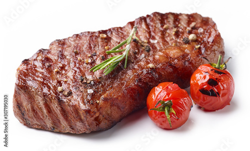 Grilled Beef Steak Isolated on white background with rosemary and tomatoes