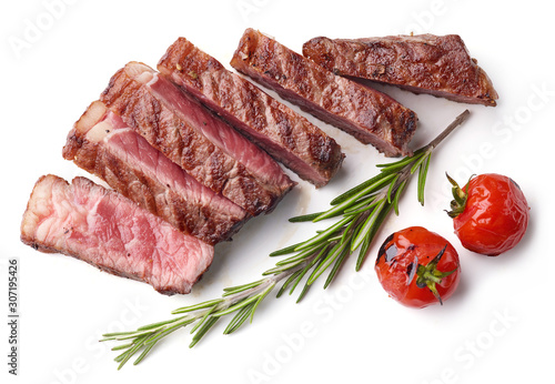 Sliced Grilled Beef Steak with tomatoes and rosemary Isolated on white background, top view photo