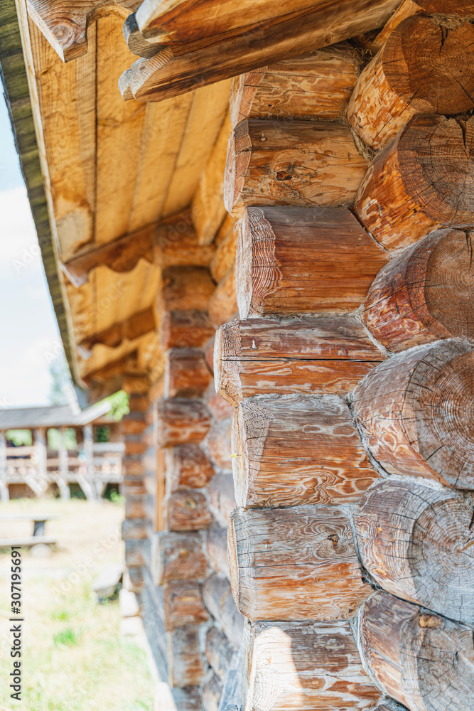 Wooden house wall, angle view of old log construction with wood texture. Vertical image and close up Wooden house wall, angle view of old log construction with wood texture. Vertical image and close up