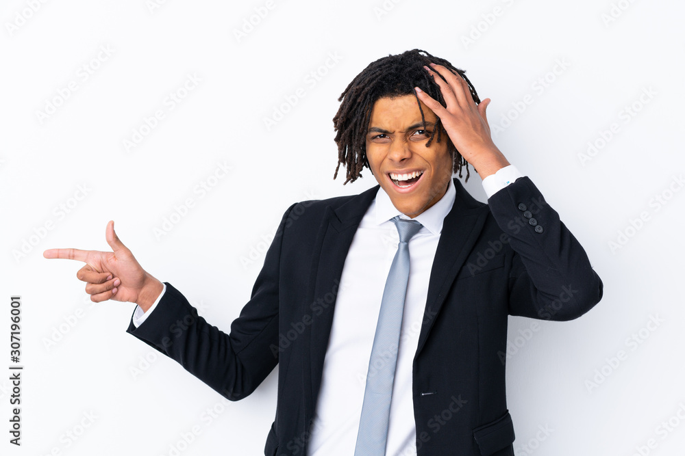 Young African American businessman man over isolated white background surprised and pointing finger to the side Young African American businessman man over isolated white background surprised and pointing finger to the side