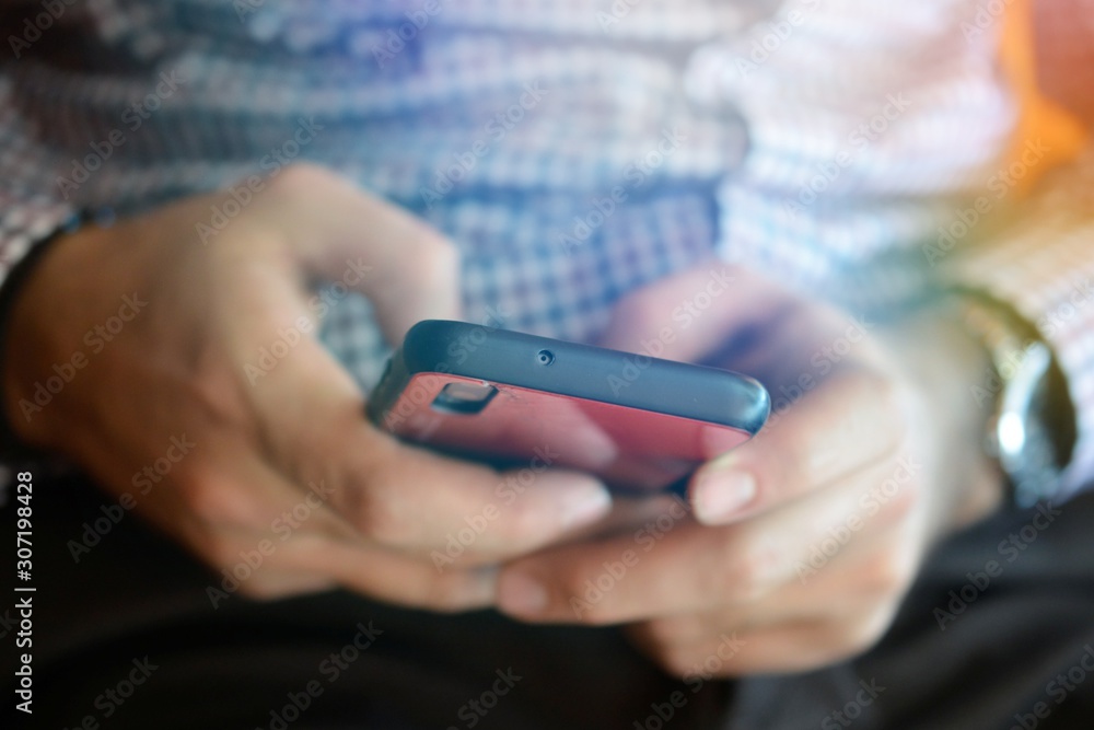 man typing on a smartphone,technology and addiction concept shallow dof
