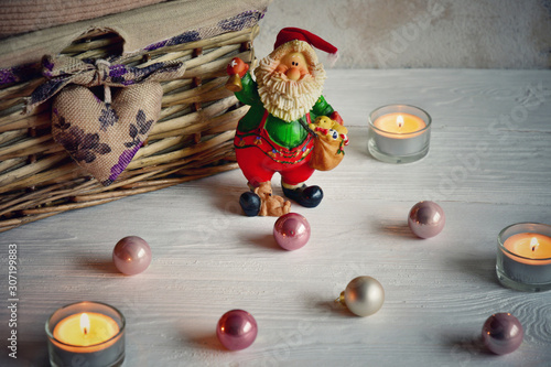 Festive background with basket, candles and Christmas decorations.