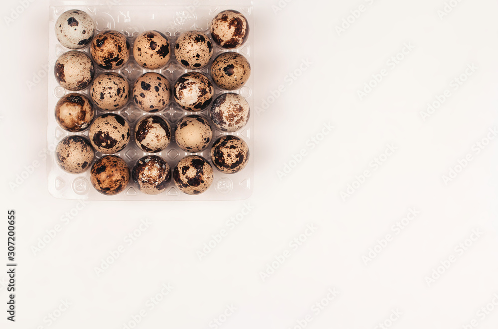 quail eggs in a box on a white background copy space quail eggs in a box on a white background copy space