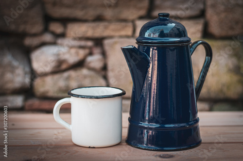 Cuadro en lienzo Old enamel coffee mug and blue  pot.