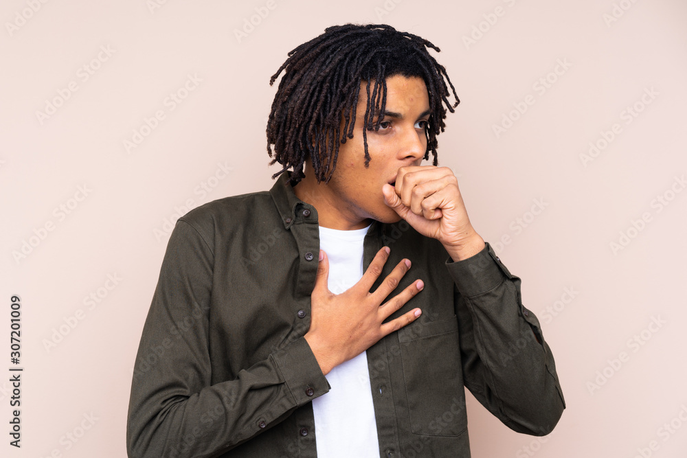 Young African American man over isolated background is suffering with cough and feeling bad Young African American man over isolated background is suffering with cough and feeling bad