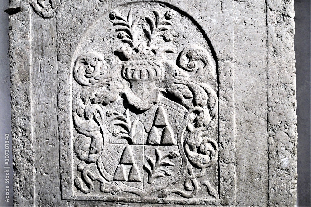 Riga, Latvia, November 2019. Coat of arms of an old family on the wall of a catholic cathedral. Riga, Latvia, November 2019. Coat of arms of an old family on the wall of a catholic cathedral.