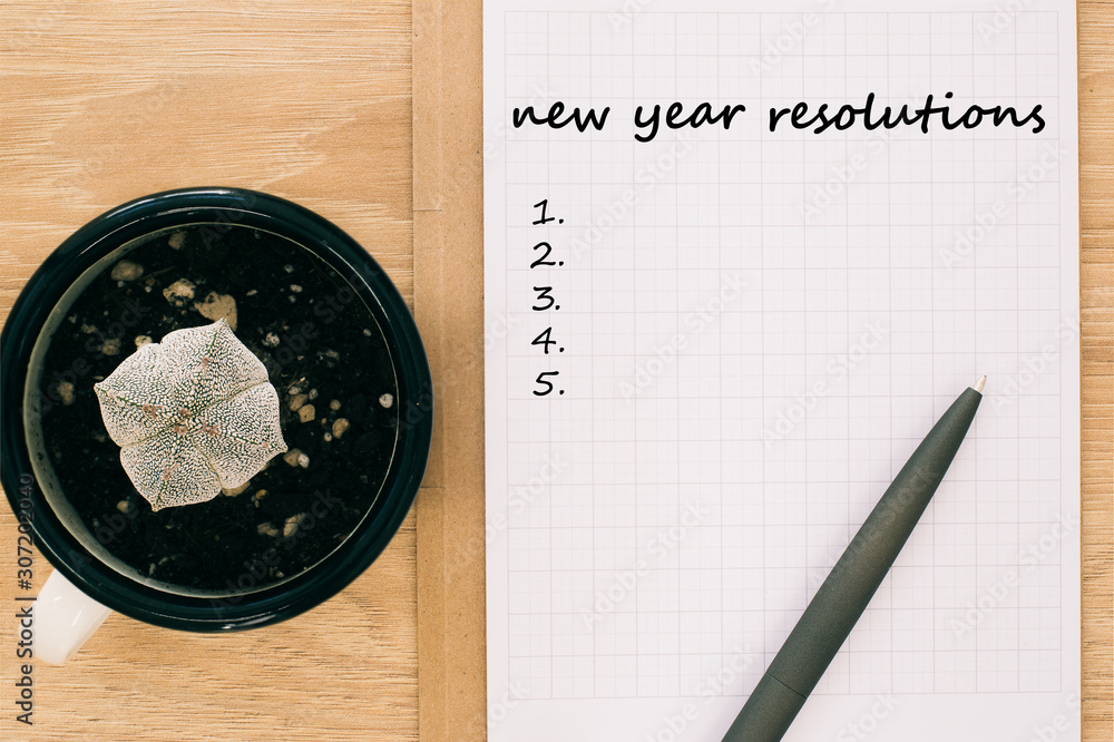 New year resolutions concept, notepad with pen and number list, top view