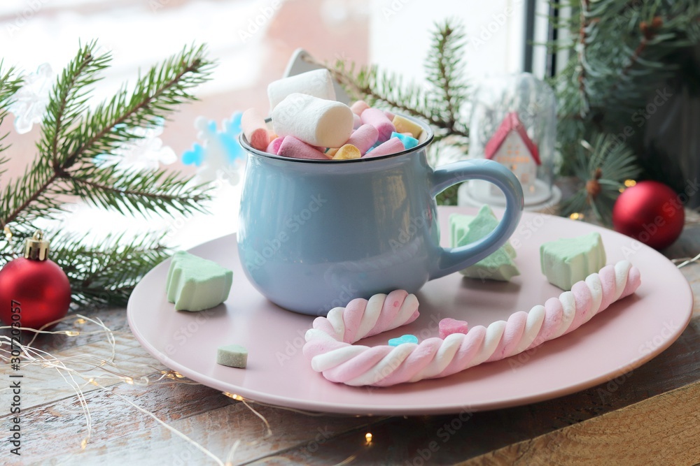 A cup of drink with marshmallows, Christmas decor, illumination on a wooden windowsill, the concept of home comfort, winter holidays A cup of drink with marshmallows, Christmas decor, illumination on a wooden windowsill, the concept of home comfort, winter holidays