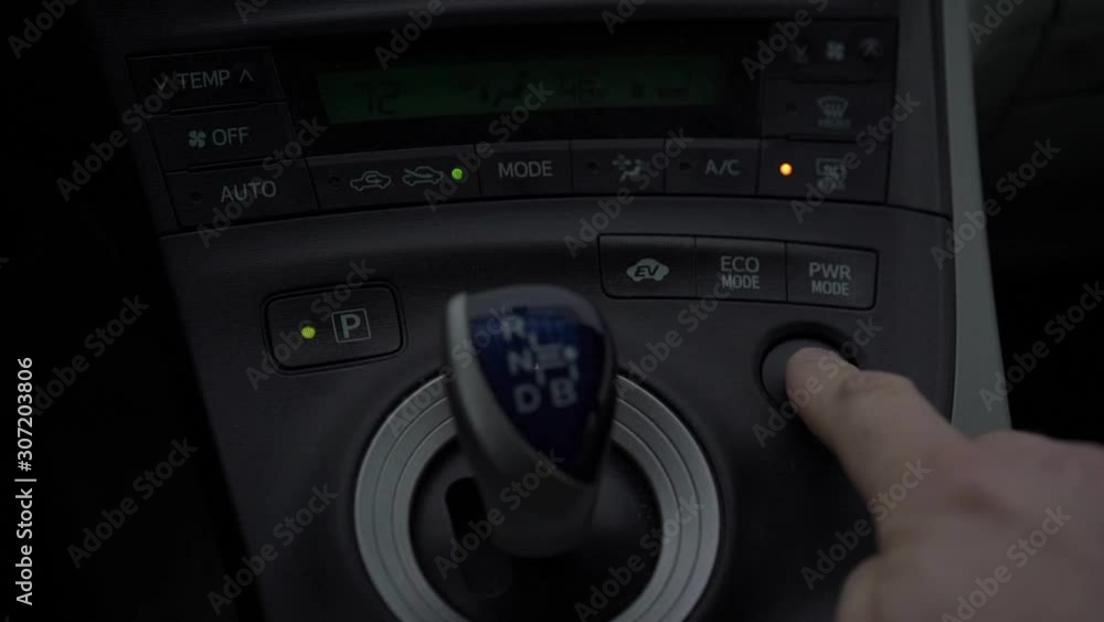 person finger presses hazard lights button near gearshift stick on black designed dashboard slow motion closeup person finger presses hazard lights button near gearshift stick on black designed dashboard slow motion closeup