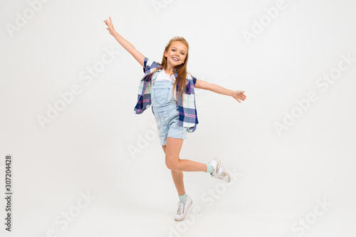 attractive european girl jumping on a white wall