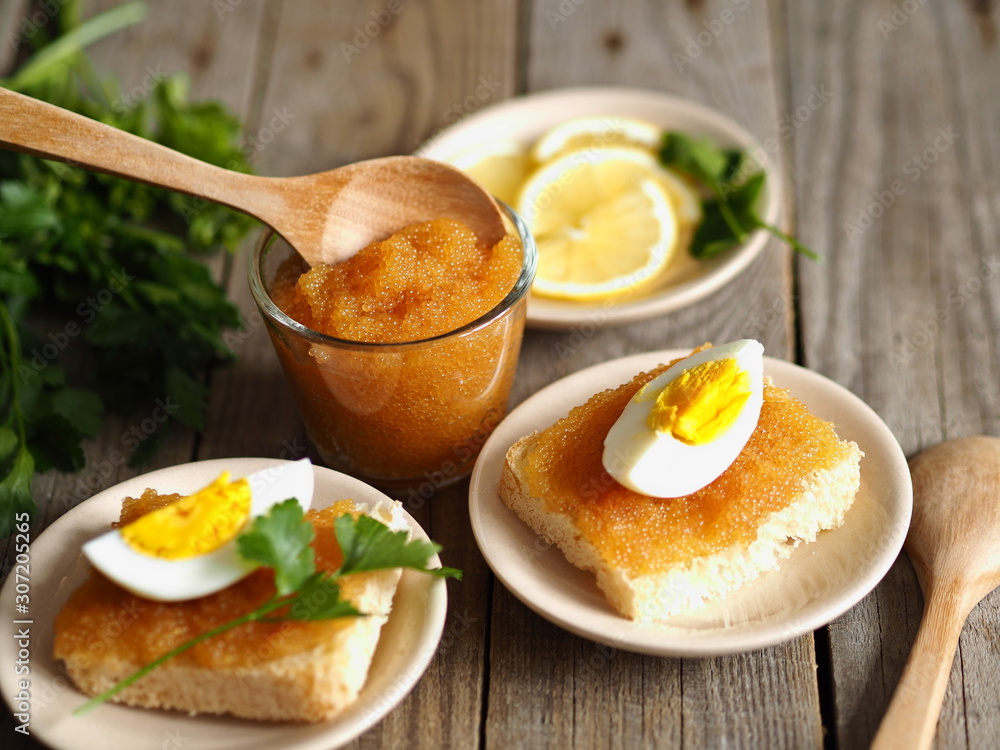 sandwiches of pike fish caviar with egg on a wooden wooden table sandwiches of pike fish caviar with egg on a wooden wooden table
