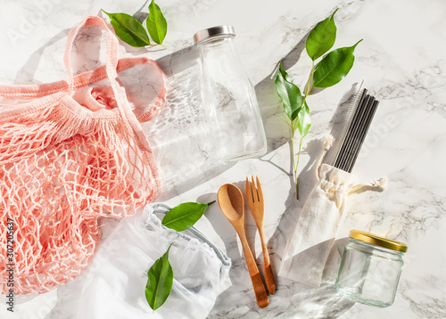 zero waste eco friendly concept. reusable cotton bag, stainless steel drinking staw, glass jar, wooden cutlery photo