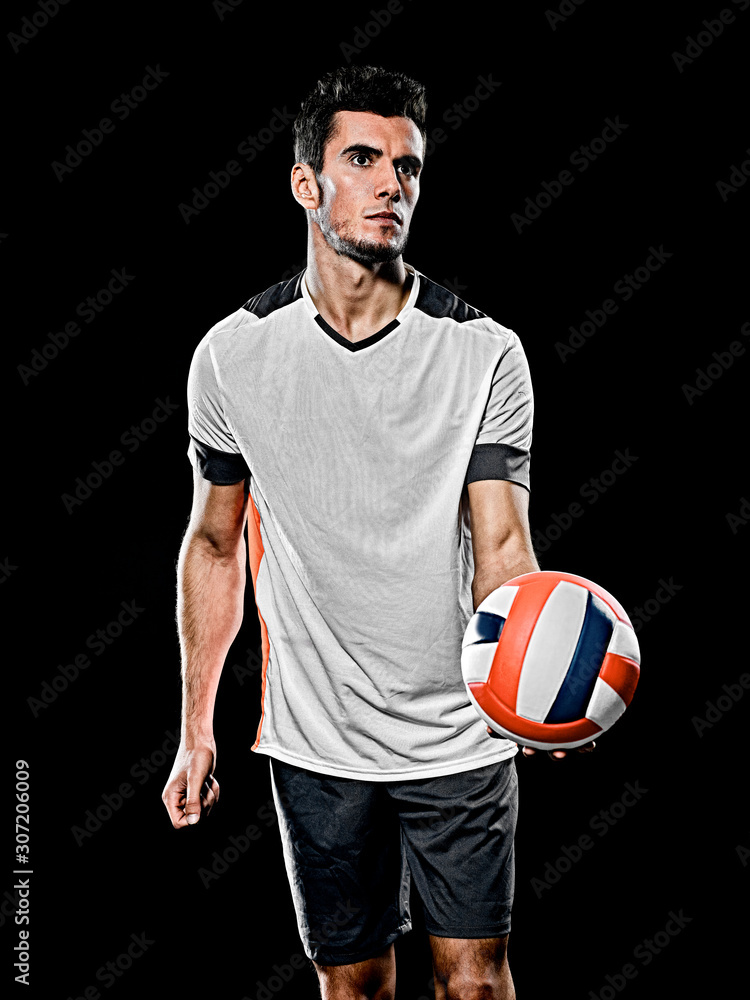 one caucasian young volley ball player man in studio isolated on black background