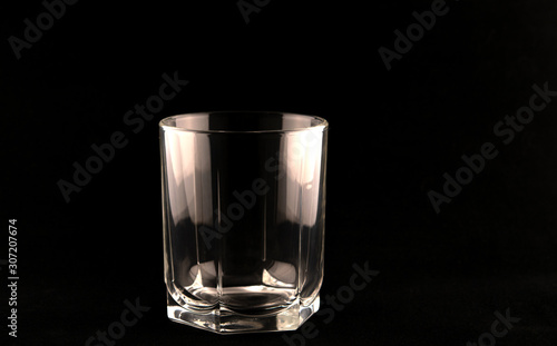 Hexagonal glass for alcoholic beverages on a black background.