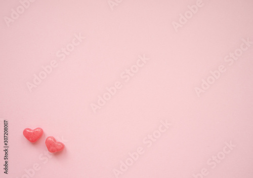 Valentines day card with tiny candy sweet hearts on pink background. Flat lay, top view, copy space. 