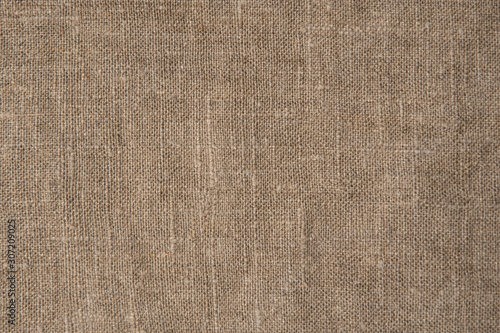 Burlap material. Rural sackcloth texture. Background from a very rough, fabric woven from linen, jute or hemp. Design element.
