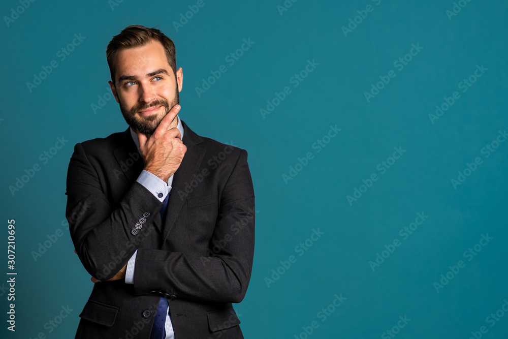 Positive thinking businessman looking up and around on blue background. Happy face expressions. Handsome male model in campaign suit. Copy space. Positive thinking businessman looking up and around on blue background. Happy face expressions. Handsome male model in campaign suit. Copy space.