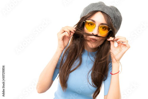 Brunette model with yellow sunglasses posing for the camera on white background © Ivan Traimak
