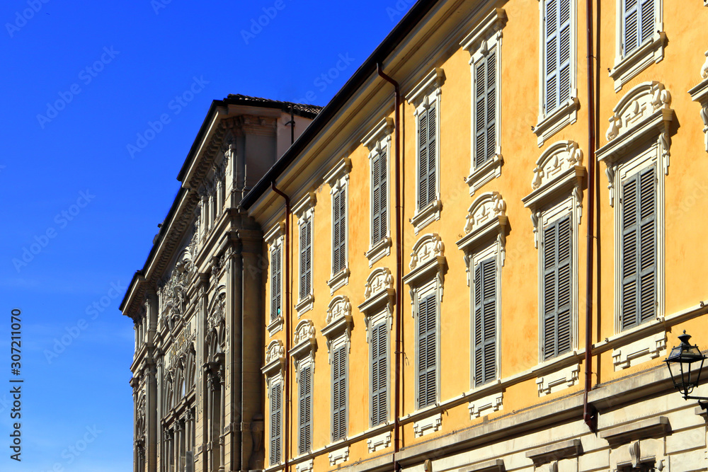 historical colored buildings in the downtown of parma city in italy