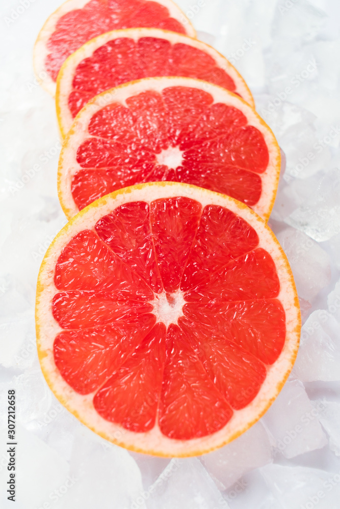Grapefruit slices on ice. Close-up. Grapefruit slices on ice. Close-up.